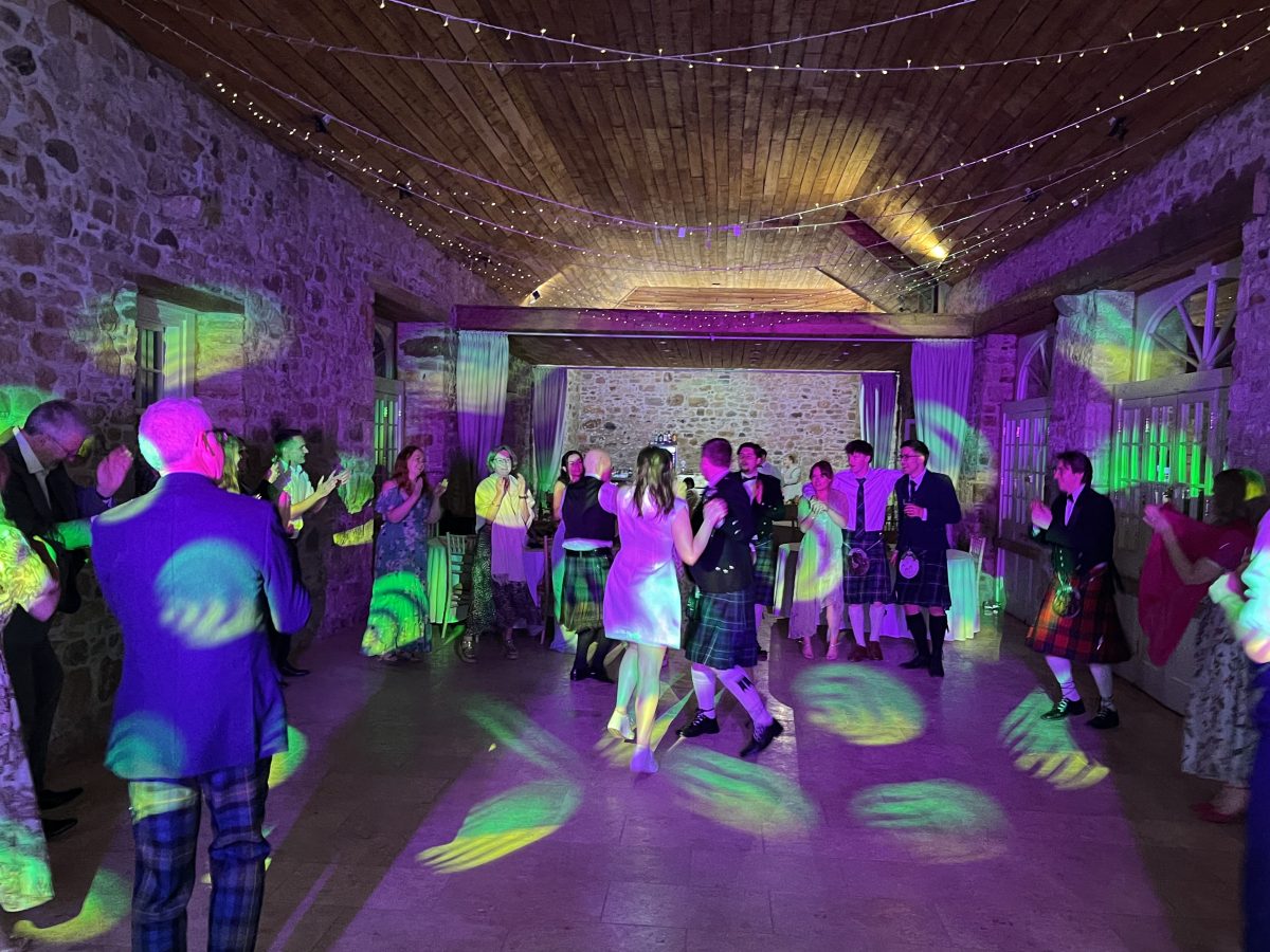 Premier disco weddings premier disco wedding dj at colstoun house, east lothian — packed dance floor with guests in kilts under colourful lighting