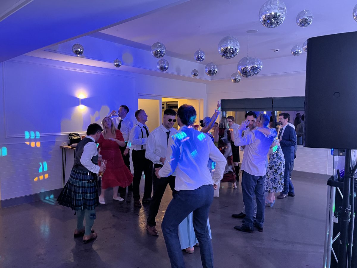 Premier disco weddings evening wedding disco in full swing at whitekirk hill — blue lighting and mirror balls
